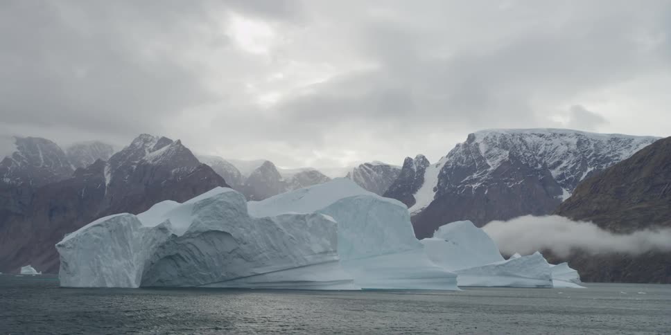 A cloudy day with the water moving slowly by ice