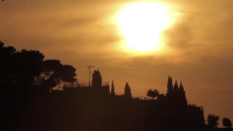 The sun peeks through the clouds near dusk