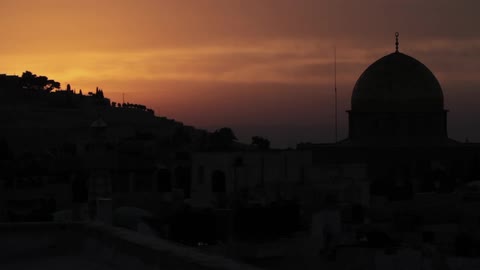 A city with a religious looking building during sunset