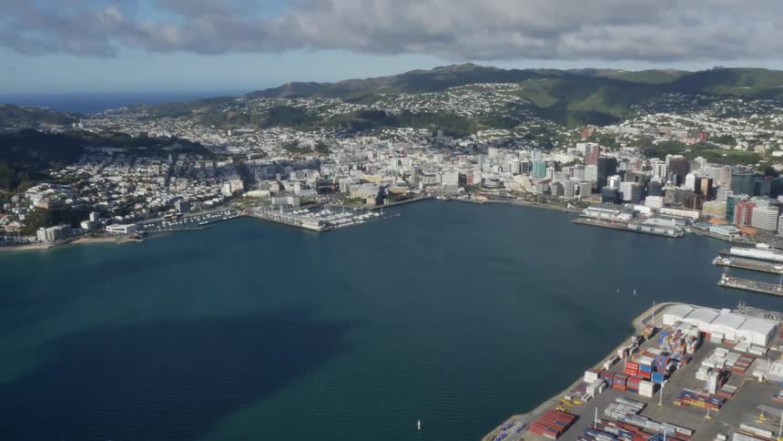 Aerial view of a coastal city with mountains in the background