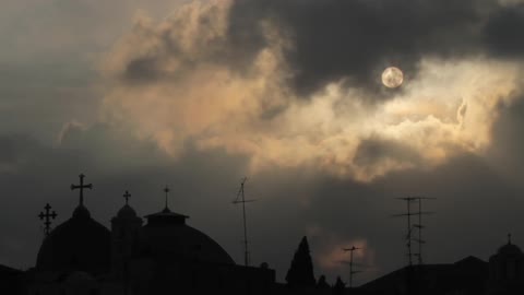 The moon is rising covering the church in shadows
