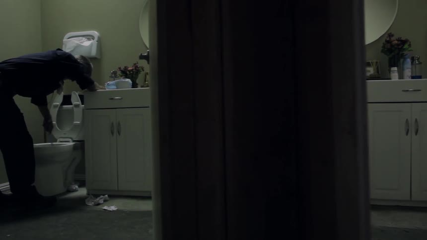 A person cleans a toilet
