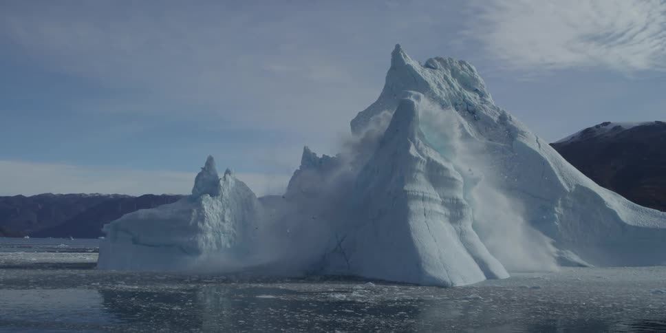 Large piece of ice on the water collapsing in the middle