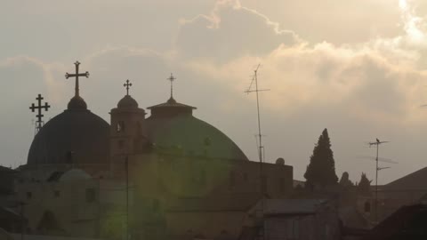 Clouds float over domed buildings