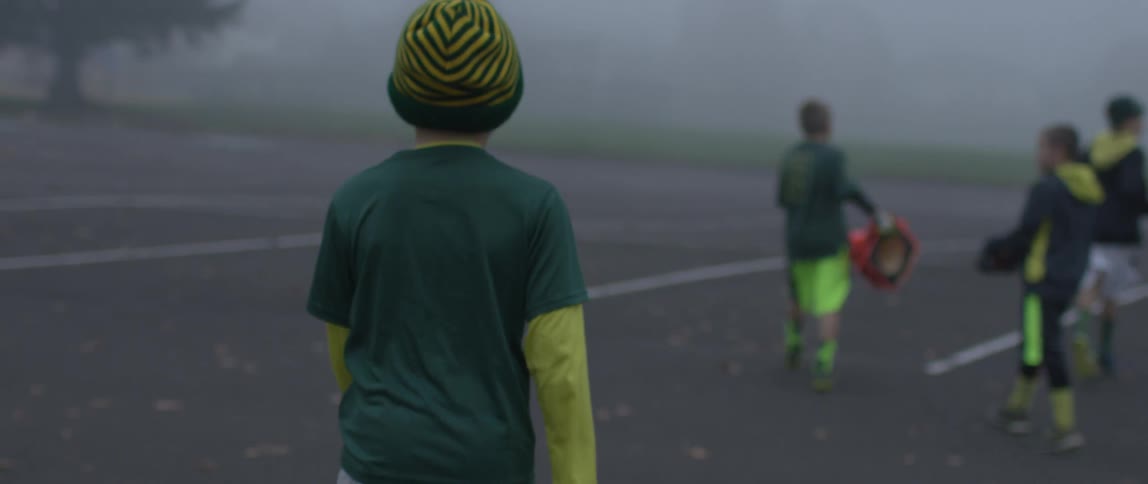 Boys walking down the road on a foggy and cold morning