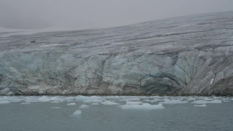 A cloudy day with ice resting on a flowing sea