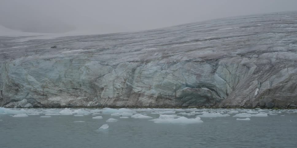 A cloudy day with ice resting on a flowing sea
