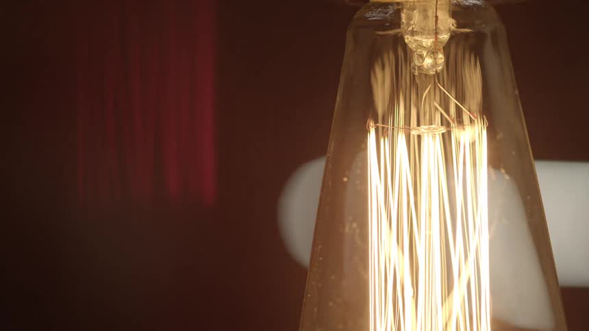 A light shining brightly in what appears to be in front of a red curtain