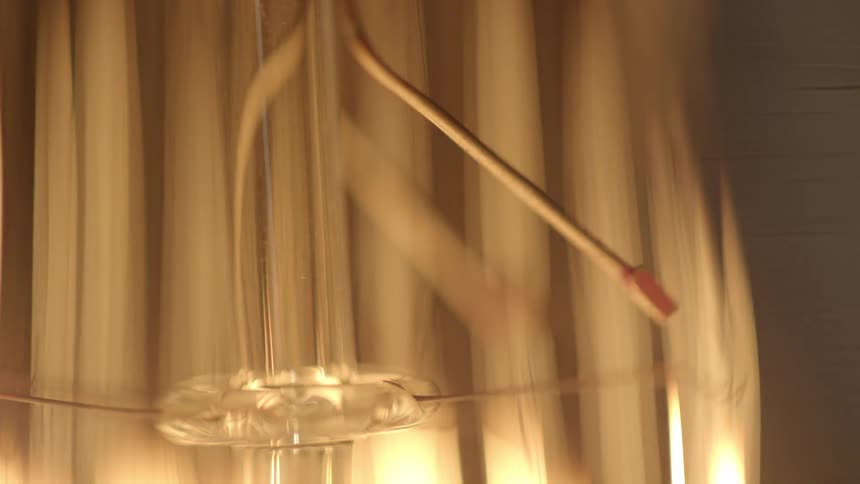 Lights illuminating a glass object in a dark room briefly,