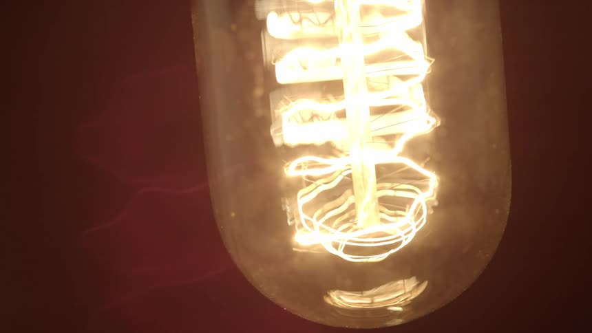 A light bulb flickers on and off