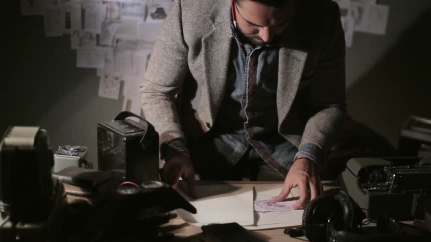 A person sitting down to use a typewriter