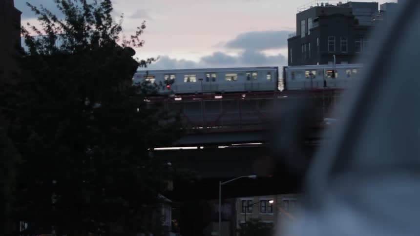 View of a train moving with the sun rising behind it