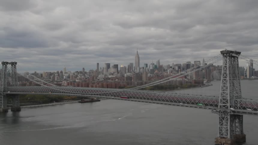 A city seen from an angle where a large bridge is in the foreground