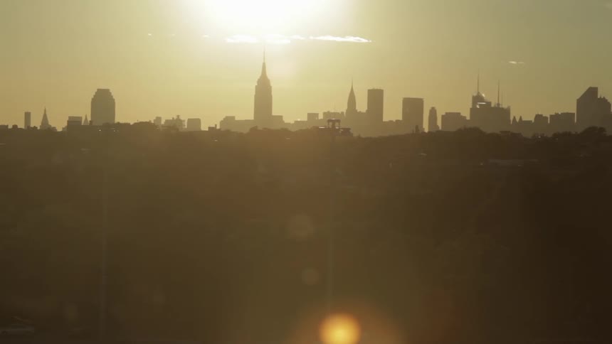A city seen during the sunrise, shining bright on the whole imagery