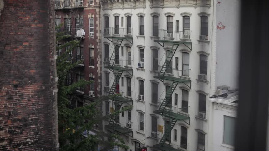 View of fire escapes on two buildings from across the street