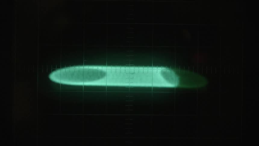 A lighted graphic flashes and spins on a screen