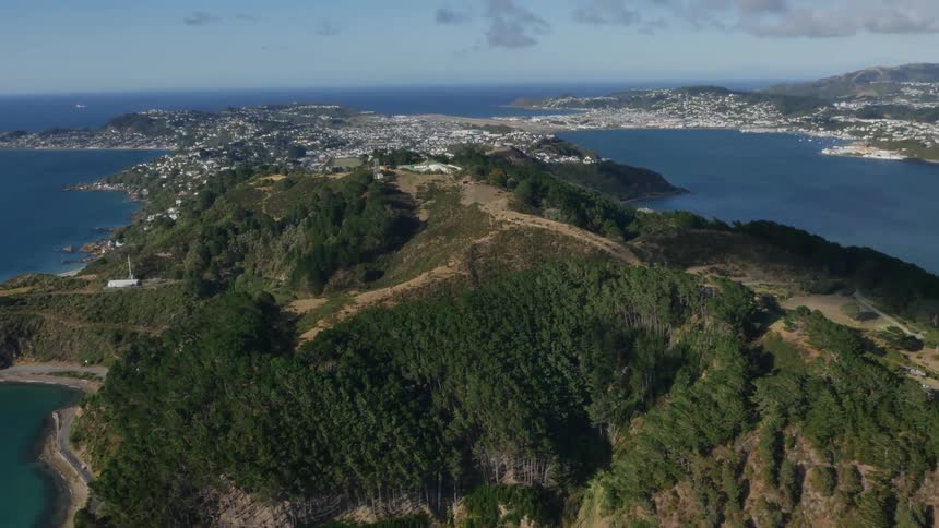 A hill sitting in front of a large city