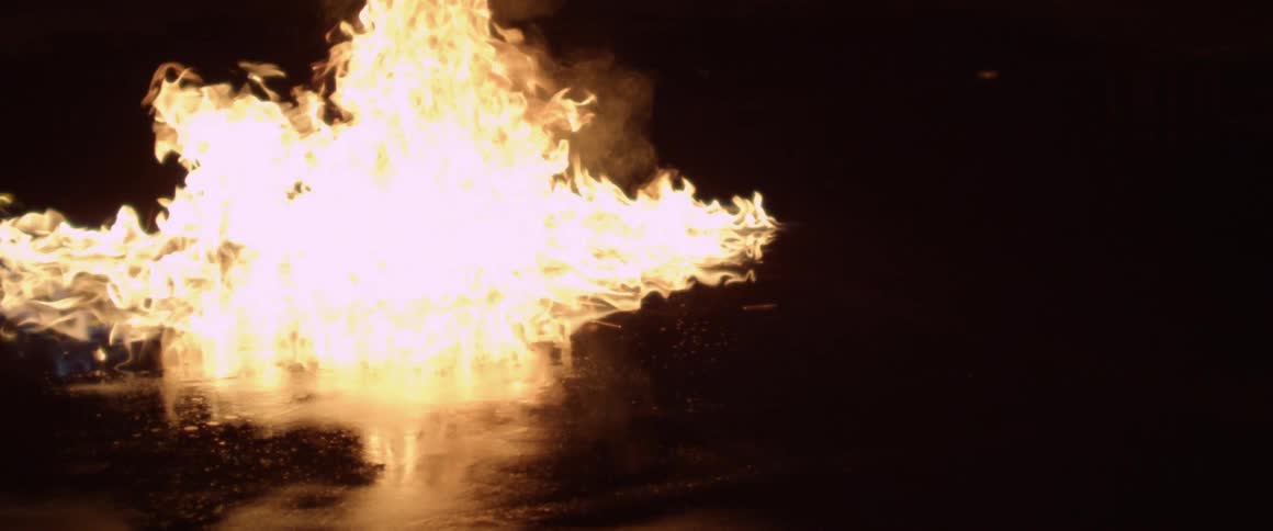 A fire burning up in the middle of a body of water