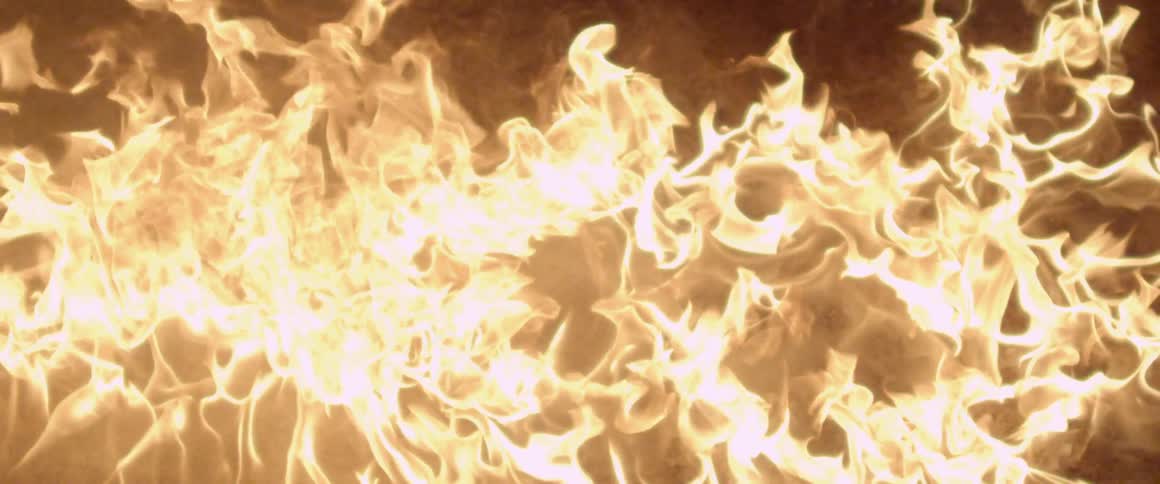 A ball of fire falling past a dark area exploding on the ground