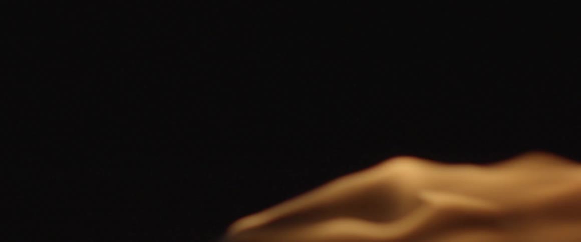 Smoke slowly billowing against a dark background