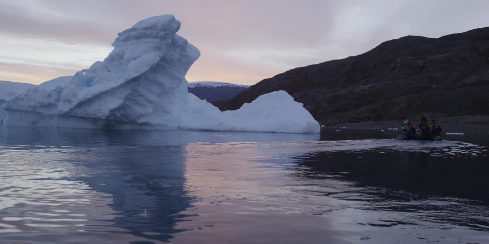 Water moving slowly past an iceberg on a cloudy day