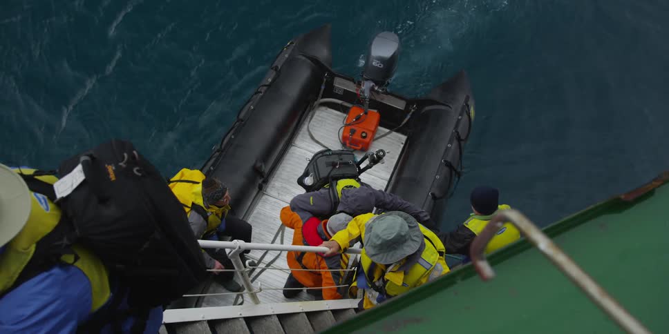 A group of people board a raft