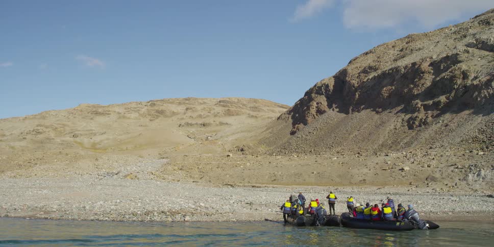 A group of people get off of rafts