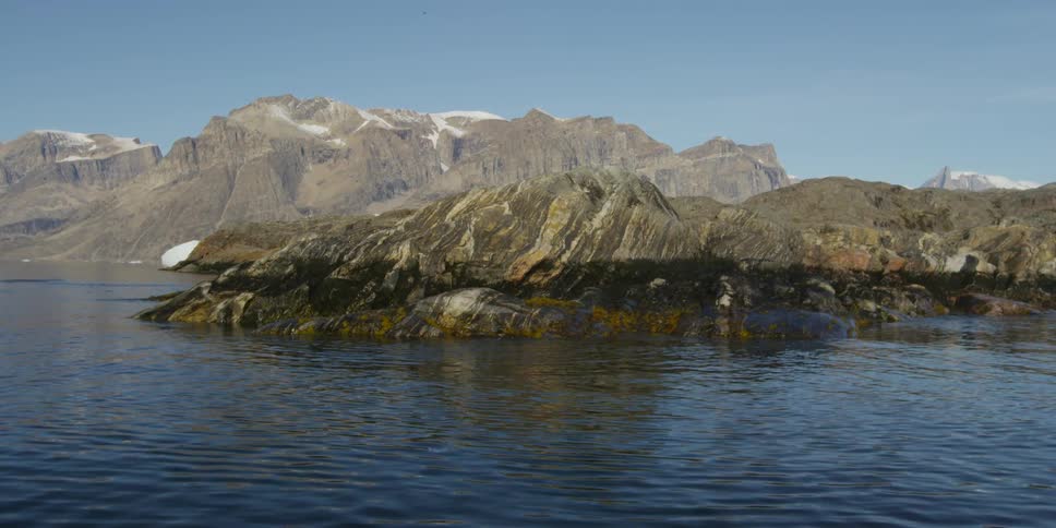 An aerial view of a rocky shoreline and cliffs