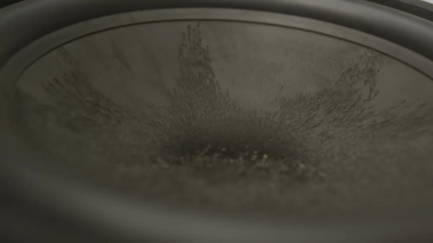 Minerals vibrate on a speaker
