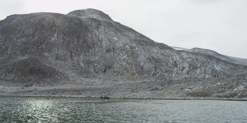 A mountain near the coast during the day