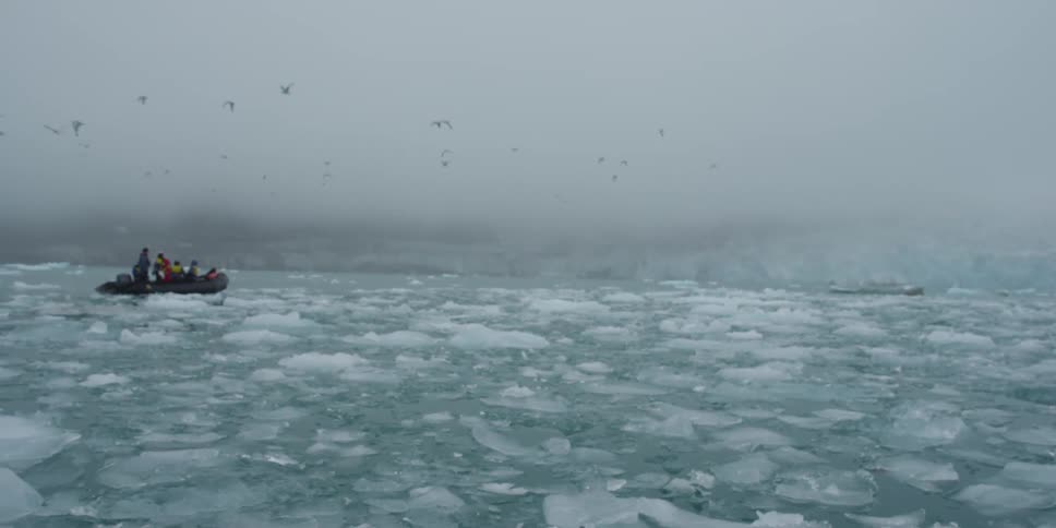 People raft through an icy lake