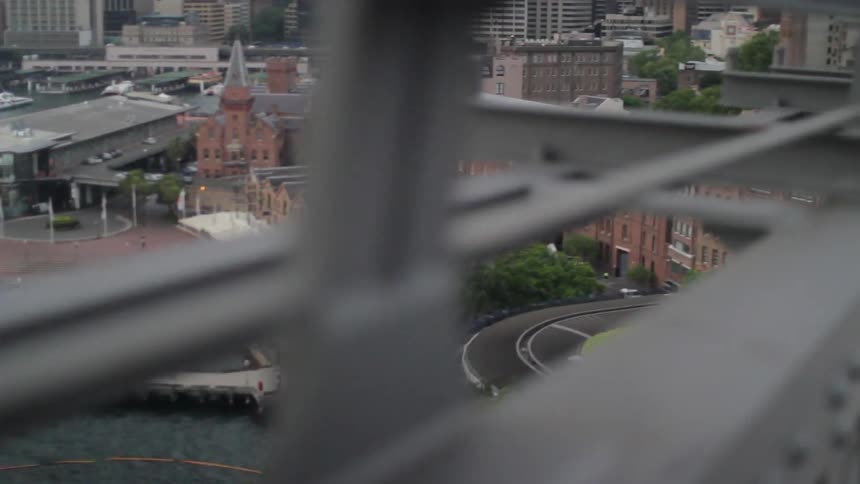 A city is shown through the side of a bridge