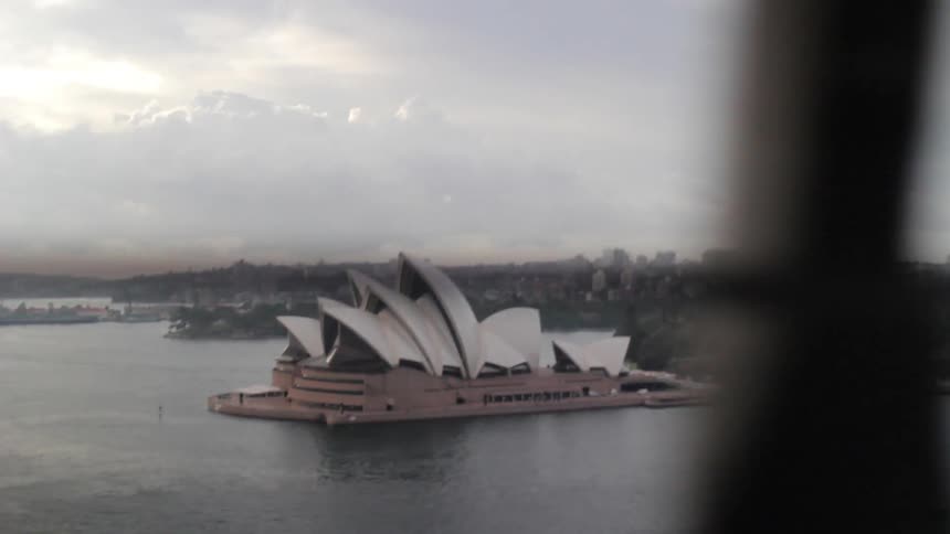 The sydney opera house as seen from a bridge