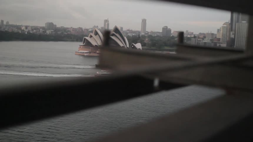 Boats float by the sydney opera house