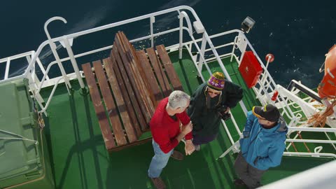People stand on a large boat