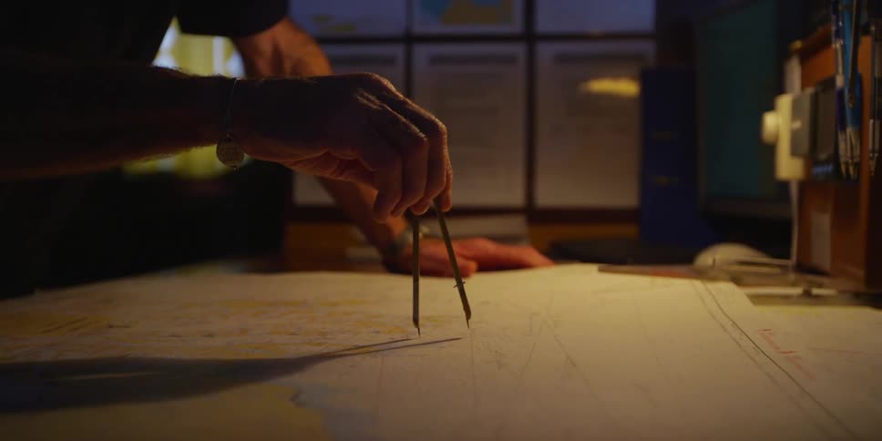 A man using a compass on a map
