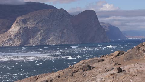 Calm waters of a river in a climate with some ice floating around