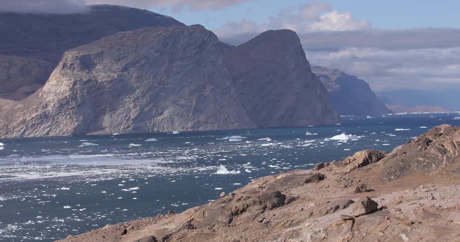 Calm waters of a river in a climate with some ice floating around