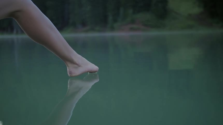 Person putting their toe in the lake water