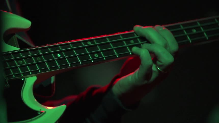 Man with ring plays guitar at night