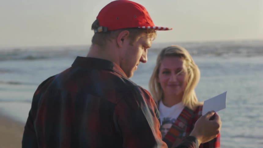 A man and a woman after taking a picture on a beach