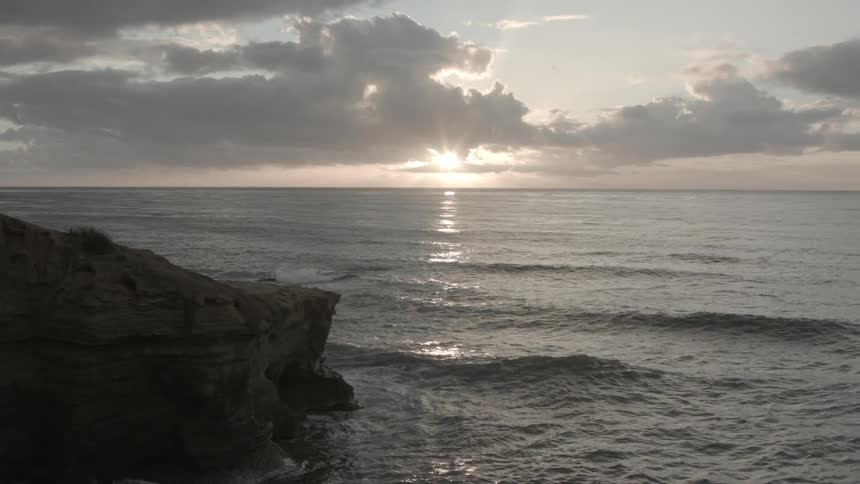 The sun is setting behind a body of water