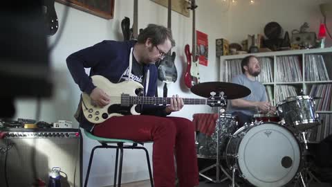 A couple of men play instruments together