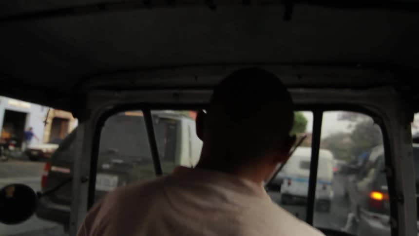A man driving down a crowded city street