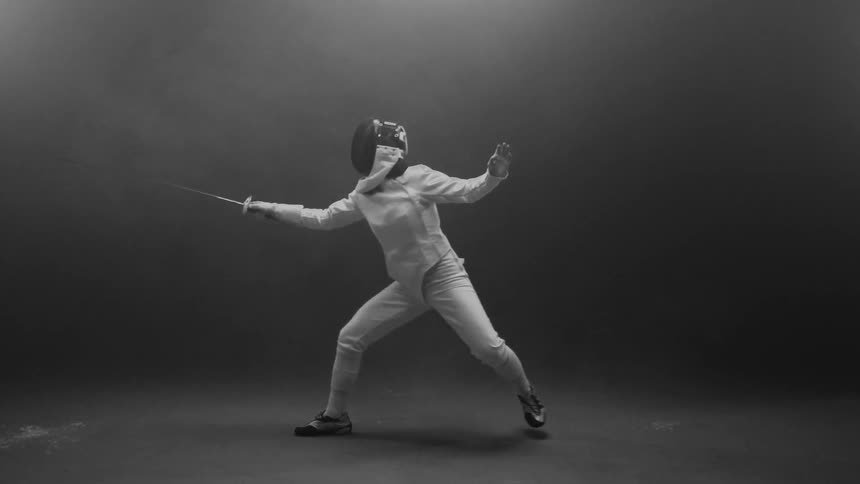 Fencer leaps forward with sword