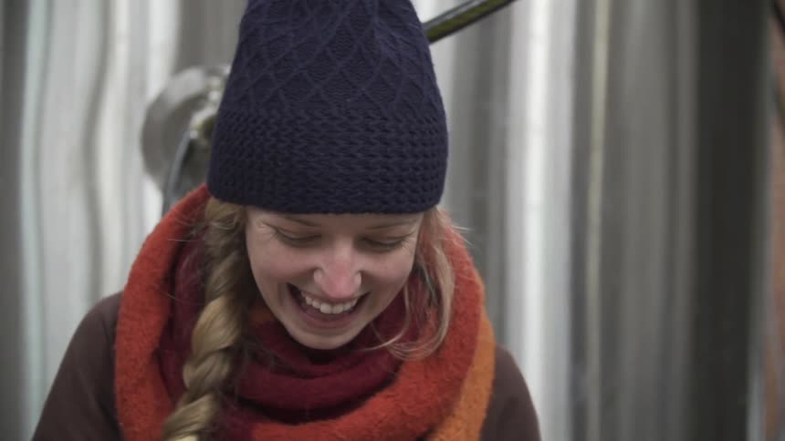 A woman with braided hair laughs