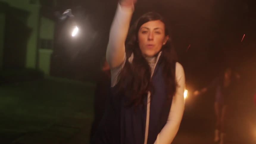 People celebrate using sparklers at night