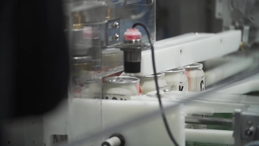 Cans move through an assembly line in a factory