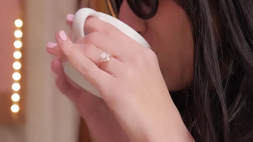 A woman drinking out of a coffee cup
