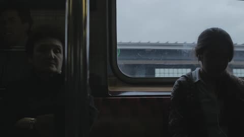 Women sitting in a commuter train as it travels through a city